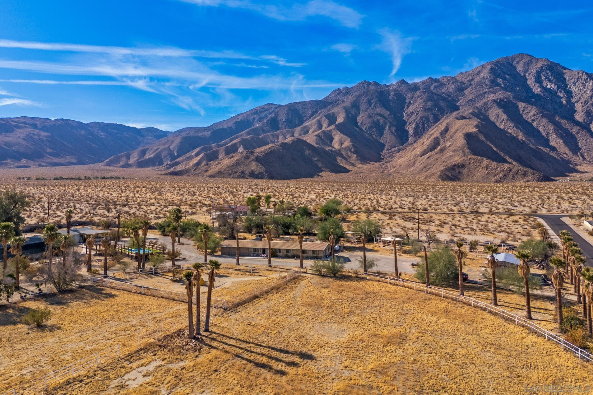 Aerial cinematic view of a vast desert valley in Coachella Valley, California at golden hour